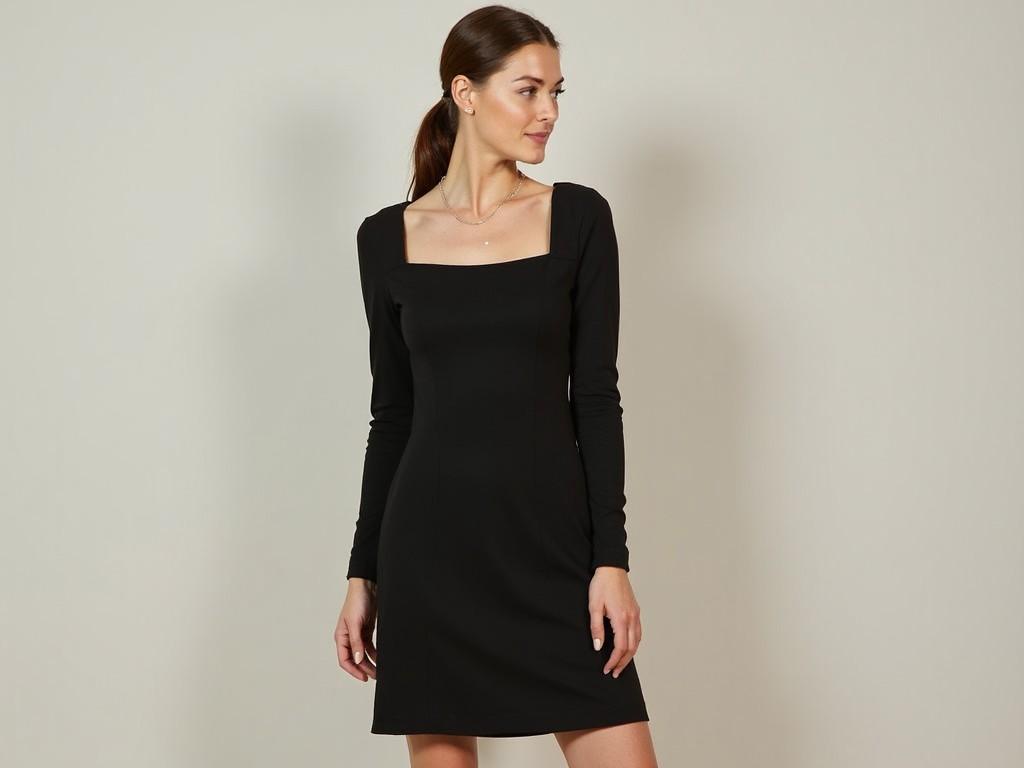 A woman wearing a black long-sleeve dress, fashion photography