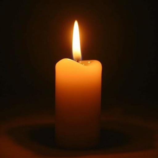 A candle stands still without any flame. Its surface is smooth and waxy. Background is dark. The candle is simple and elegant in appearance.