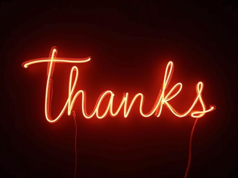 Neon light text saying 'Thanks', glowing red against a dark background, with a vibrant and artistic presentation.