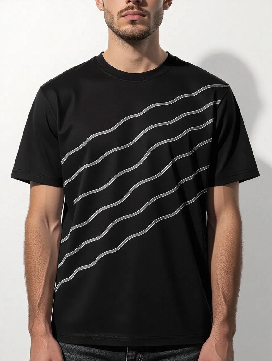 Black t-shirt worn by a model with stylized white lines across the chest and shoulder creating an illusion of fabric bending. Abstract geometric design gives a bold streetwear vibe. Background features an urban graffiti wall with a spotlight from the side.