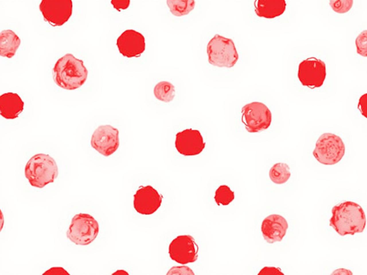 The image displays a repeating pattern of red circles on a white background. There are solid red circles alongside outlined red circles. The arrangement creates a playful and vibrant design. The circles come in various sizes and are grouped in clusters throughout the image. The overall feel is cheerful and simple, suitable for backgrounds or fabric prints.