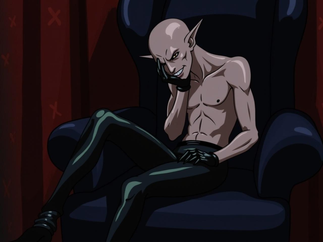 The image features a fictional character sitting on a dark blue armchair. The character has a pale, slender physique, with elongated ears and sharp facial features. They are dressed in glossy black gloves and pants, showcasing their unique appearance. The background is dimly lit with red curtains and various shadows, contributing to a mysterious atmosphere. The character seems contemplative, resting their head on one hand. Overall, the scene evokes a sense of intrigue and fantasy.