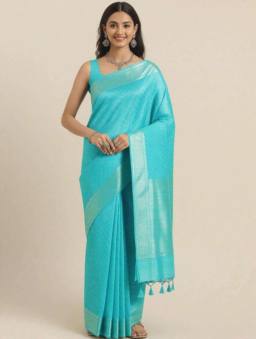 Beautiful girl standing with joining hands wearing a blue saree along with necklace and earrings and sandals