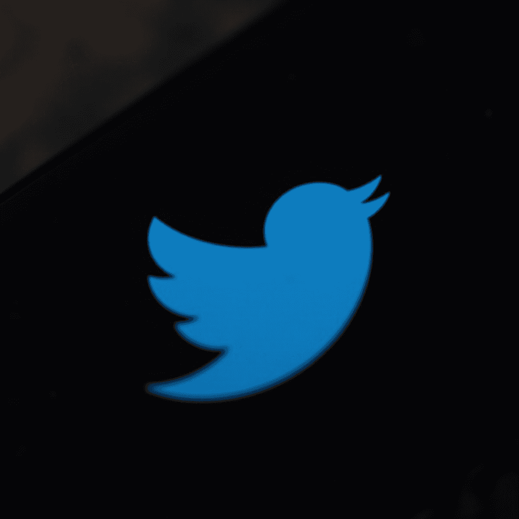 This image features a blue bird icon, commonly associated with the Twitter logo, set against a dark background. The bird is stylized, with a streamlined shape and upward-sweeping tail and wings, giving the appearance of being in flight. The simplicity of the design is highlighted by the contrast between the vibrant blue of the bird and the black background, making the icon stand out prominently.