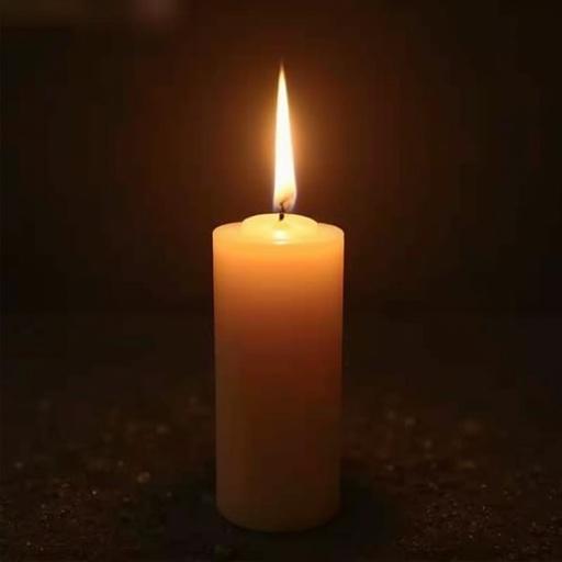 A single candle with a soft, flickering flame against a dark background. The candle is cylindrical and appears to be made of wax. A warm, inviting light glows from the flame, enhancing the serene atmosphere.