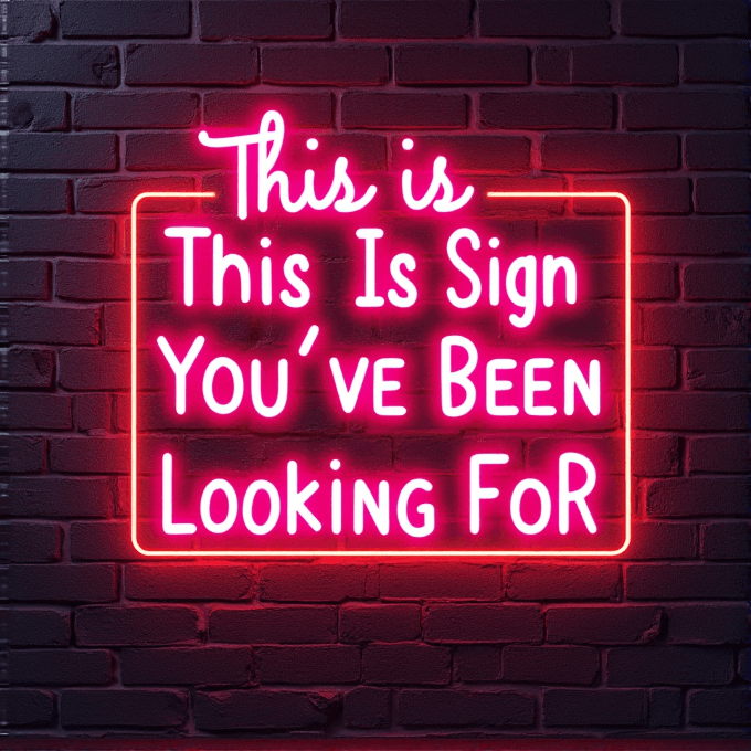 A pink neon sign on a brick wall reads 'This Is The Sign You’ve Been Looking For.'