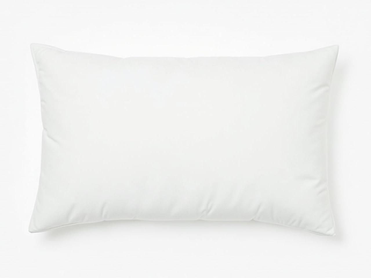 The image features a plain white pillowcase, which is neatly aligned and appears to be fluffy. The fabric has a glossy finish that reflects light subtly. The pillow has a rectangular shape and is of standard size, suitable for a bedside or couch. The background is simple and plain, focusing all attention on the pillow. The overall aesthetic is clean and minimalistic, making it suitable for a variety of home decor styles.