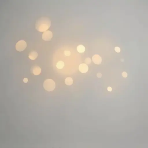 Background with minimal bokeh light circles in light yellow and soft orange tones. Softly glowing circles with varied sizes and brightness on a smooth medium gray background. The design is minimalist and calming with no visual clutter.