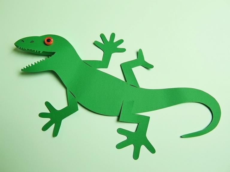Image of a rudimentary lizard made with cut-out green paper shapes