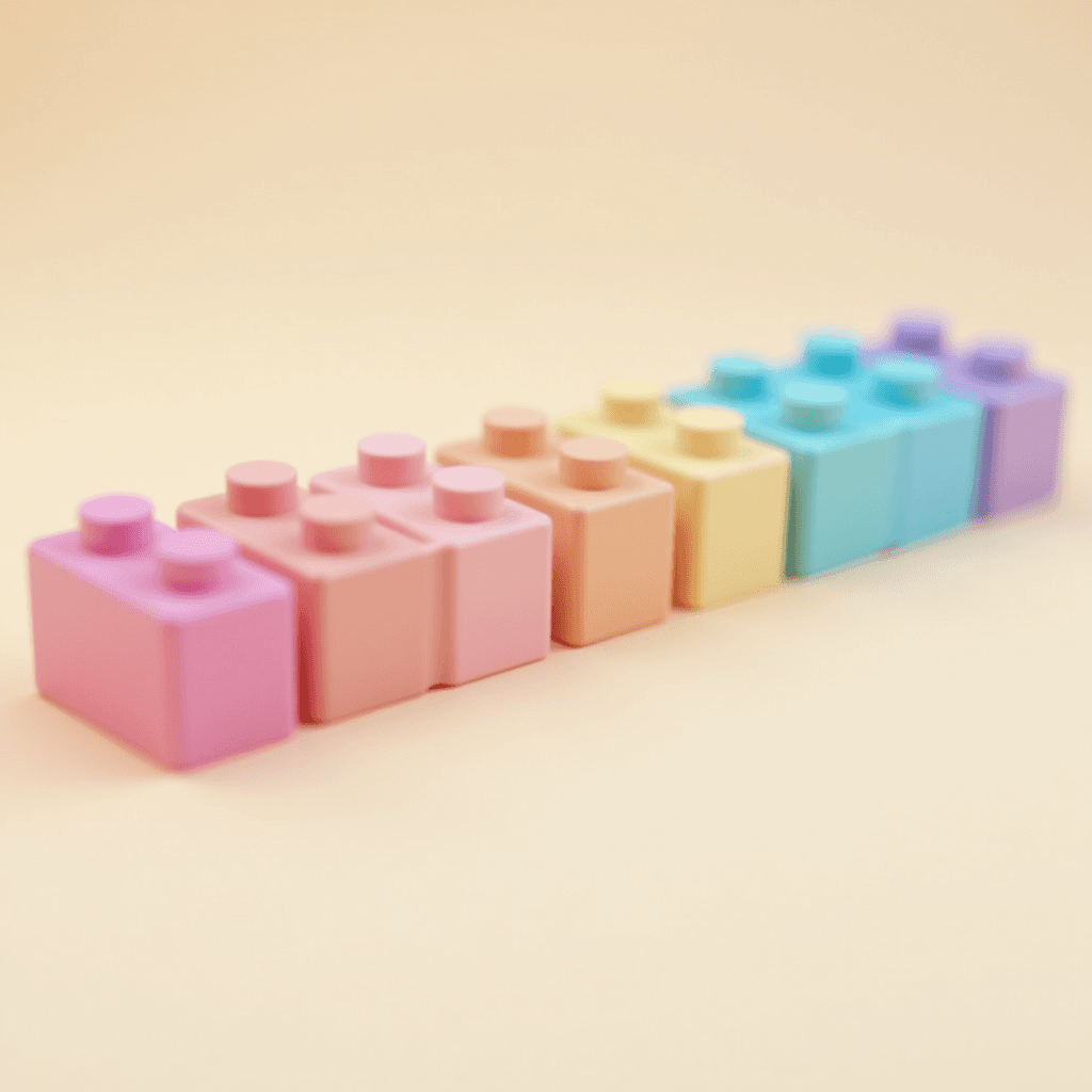 A row of pastel-colored toy building blocks arranged in a gradient on a light background.