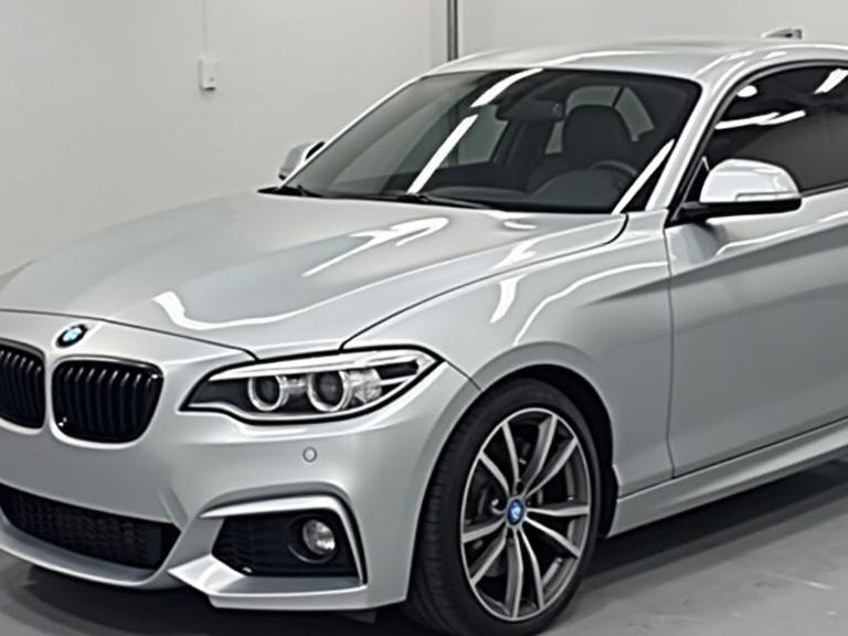 Showcase a silver metallic BMW car. Highlight the shiny paint finish. Ideal for automotive service promotion. Clean background for focus on car details.