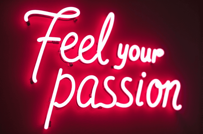 Neon pink letters spell out 'Feel your passion' against a dark background.