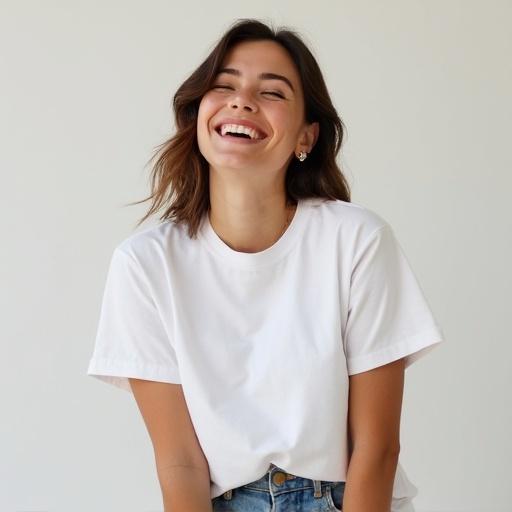 Woman wearing a basic white t-shirt laughing in a bright setting
