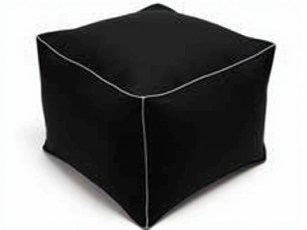 The image shows a black, square-shaped object with a sleek design. It appears to be made of a soft material, possibly foam or padded fabric. There are thin, white stripes running across the top and around the sides, adding a touch of contrast to the overall black color. This object might serve as a cushion or seating option. Its compact size suggests it could be used in various spaces, such as a living room or an office. Overall, it combines simplicity and modern aesthetics.