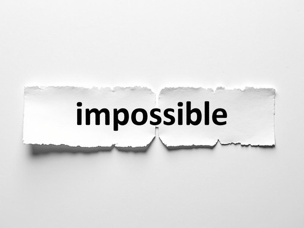 A photograph of a stripe of paper featuring the word 'impossible'. The text is uniquely divided by a tear between the letters 'im' and 'possible'. The torn edge adds an artistic touch, emphasizing the contrast between the two sections. The background has a subtle texture that complements the simplicity of the paper. The 'im' part is in bold black, while the 'possible' is also in black, but slightly lower to create a visual interest. Overall, the image conveys a message of overcoming obstacles through the wordplay in the text.