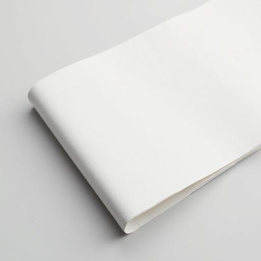 Folded edge of a white sheet of paper shows texture and subtle shadows.