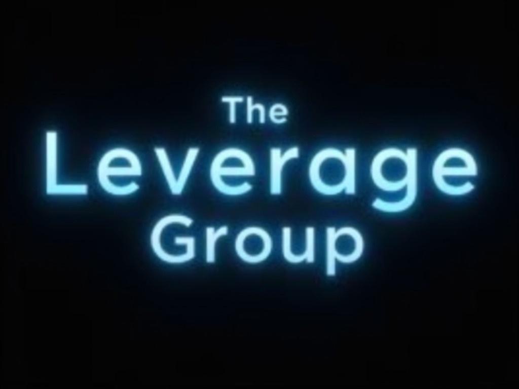 Change the font to Layton for the text 'The Leverage Group'. Remove the black background to create a clean, transparent look. Maintain the glowing effect around the letters, ensuring the glow complements the new font style. Keep the color scheme in shades of light blue to enhance the ethereal quality of the text. Ensure that the overall composition is balanced and visually appealing.