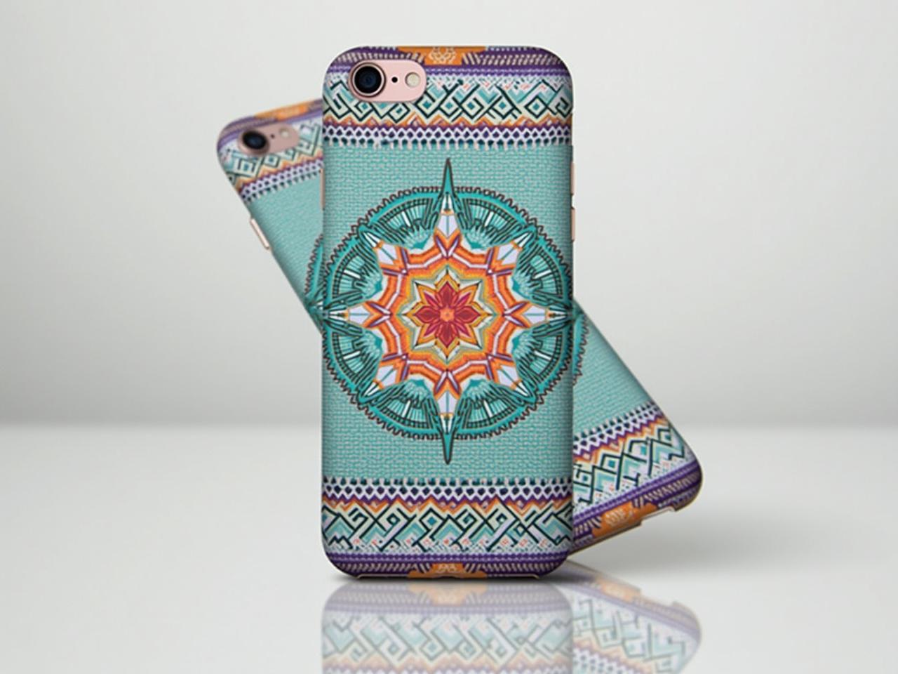 A detailed image of a phone case featuring intricate geometric patterns in vibrant colors. The design includes elements of turquoise, orange, and purple, creating a striking visual appeal. The phone case fits an iPhone and has a textured finish. The backdrop is plain, ensuring the focus remains on the case. Light reflections on the surface highlight the protective features of the case.