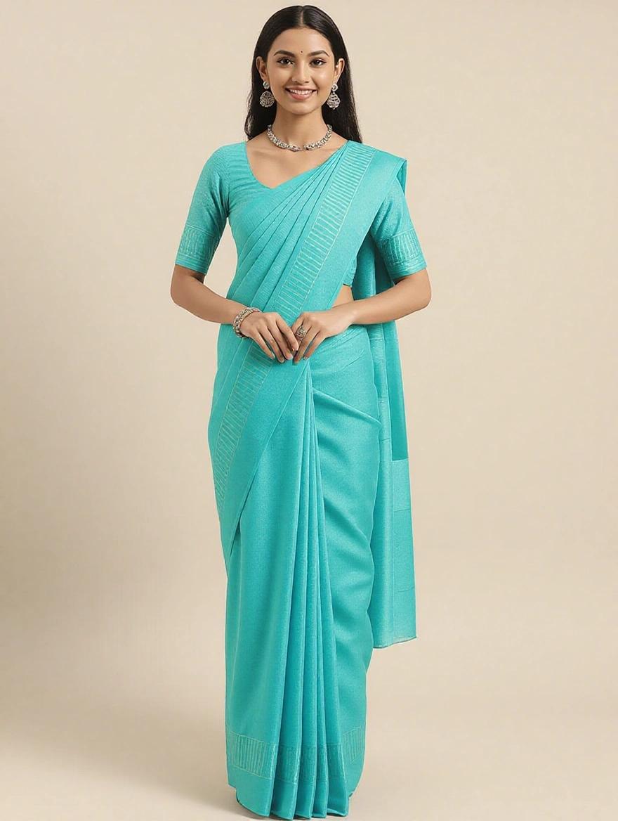 Full body view of a girl with joined hands. She wears a blue saree. She is adorned with a necklace and earrings. Nice sandals complete her look.