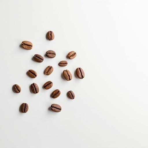 White tabletop with scattered coffee beans