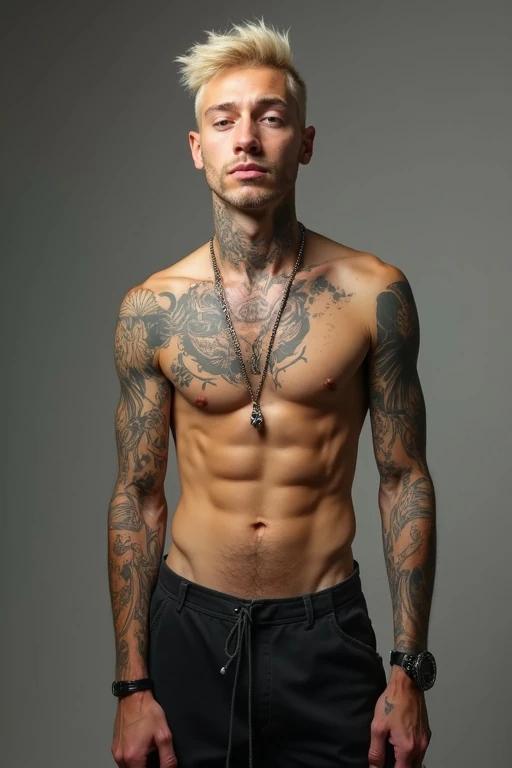 A slim and tall man with a slender frame and lean medium build. He has a light complexion and short bleached blonde hair. His body is adorned with visible tattoos. He wears jewelry including a necklace and a watch. He poses confidently against a neutral background.