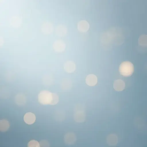 Clean background with softly glowing bokeh light circles in light gray and baby blue. Varying sizes and brightness of bokeh lights. Smooth medium gray background. Minimalist, calming effect with no distractions.